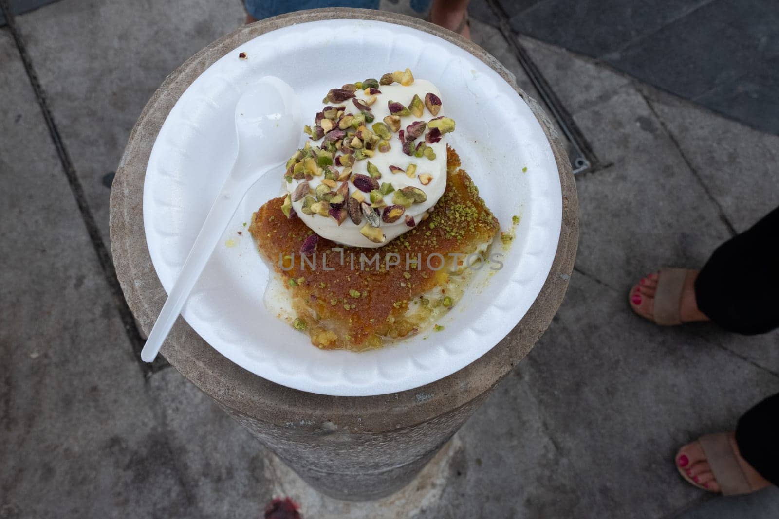 Arabic dessert Kunafa made with cheese and honey and pistache with ice cream