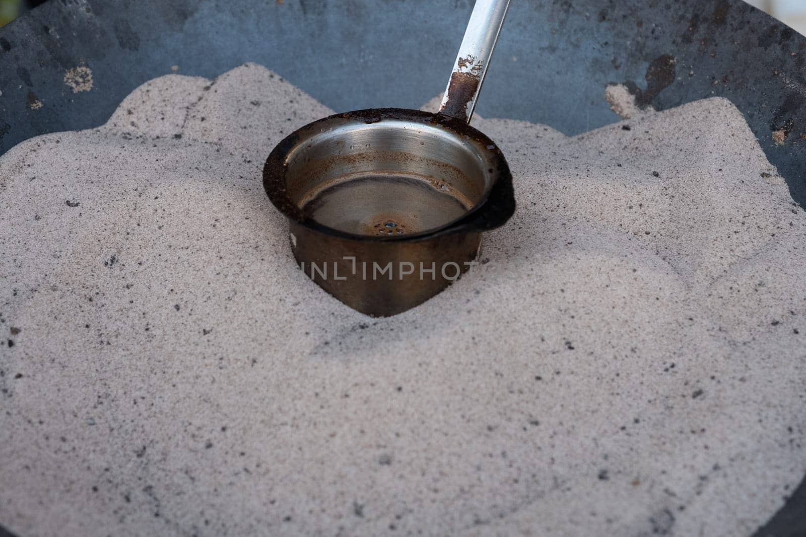 Preparation of desert arabic coffee on hot sand