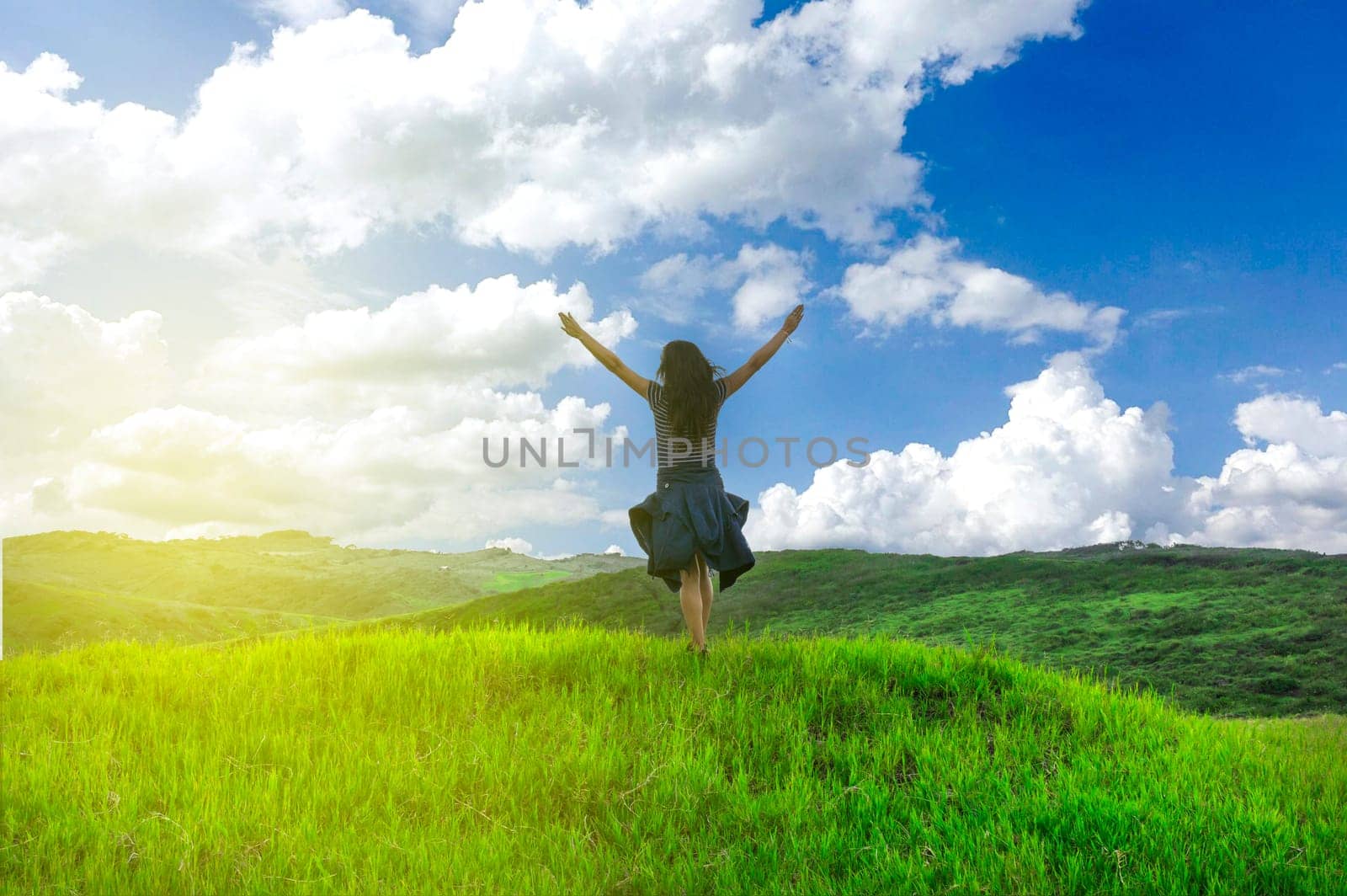 woman in the field spreading her hands, concept of woman in the field in freedom