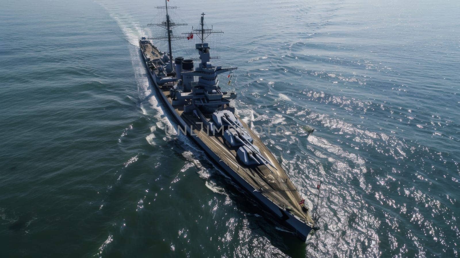 An aerial perspective of a navy ship cruising through the vast ocean waters. The ships deck is busy with crew members carrying out various tasks, while the surrounding ocean stretches endlessly to the horizon.