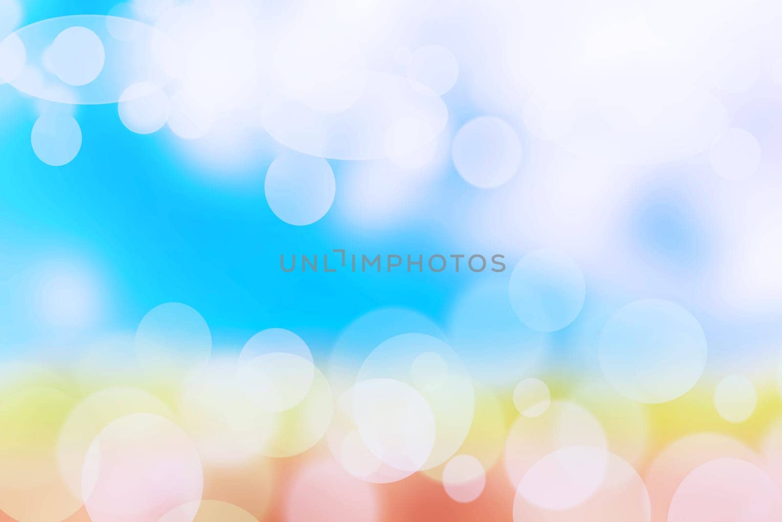 Abstract bright gradient motion spring or summer landscape texture background with natural orange yellow bokeh lights and blue bright sunny sky. Beautiful backdrop with space for design.