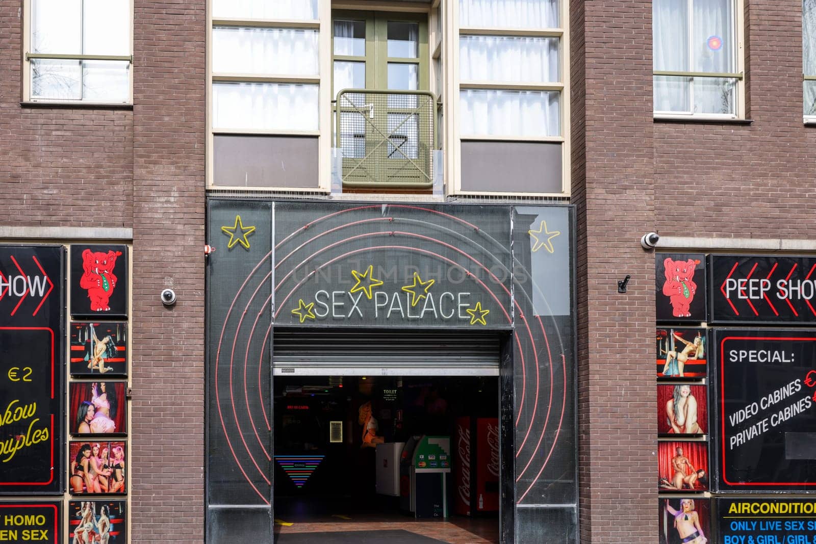 Amsterdam, Netherlands - April 21, 2023: Strip club with live sex shows in De Wallen called the red light district famous for its entertainment character: brothels, coffee shops, pubs and restaurants