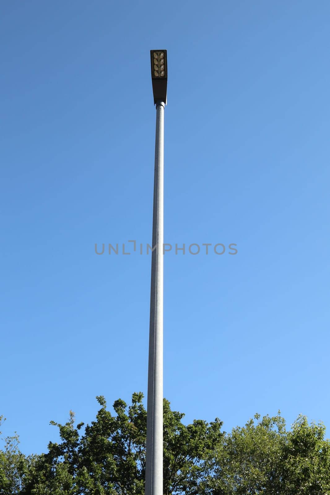 A rectangular street lamp, blue sky in the background