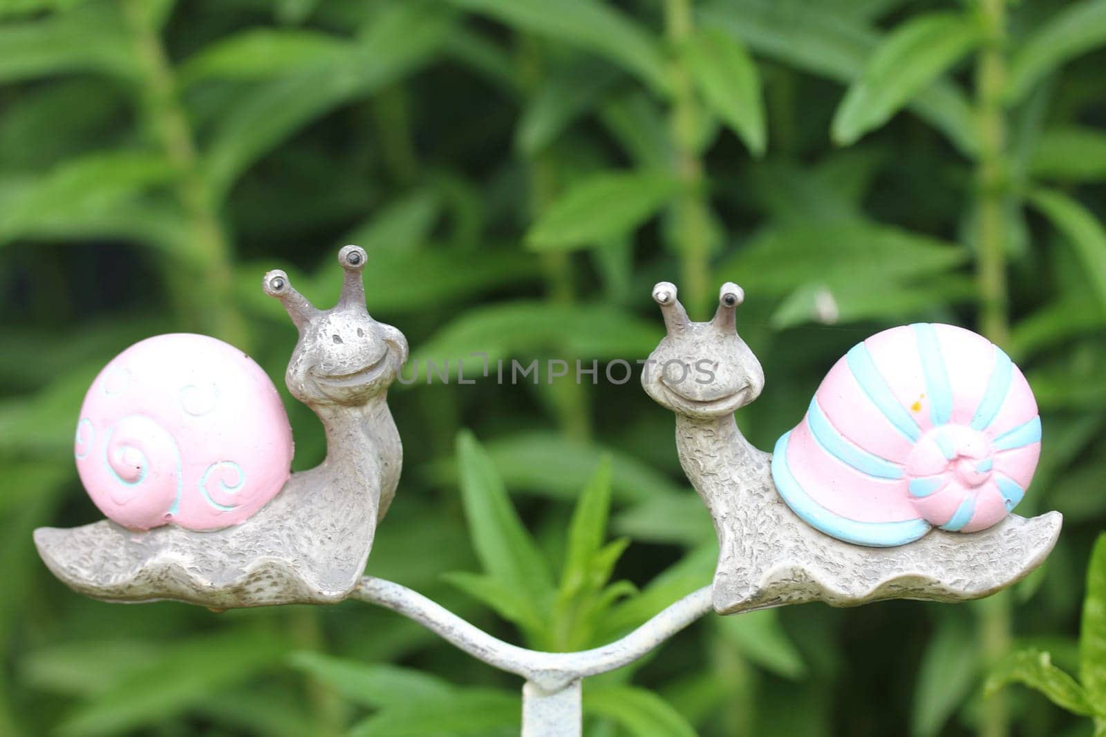 A snail from rusted metal for garden decoration