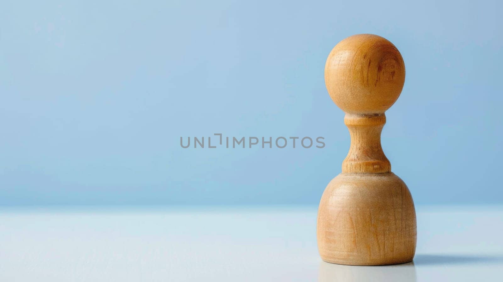 A wooden stamp with intricate designs is displayed against a solid blue background. The stamp appears well-crafted and durable, ready for use in various applications.