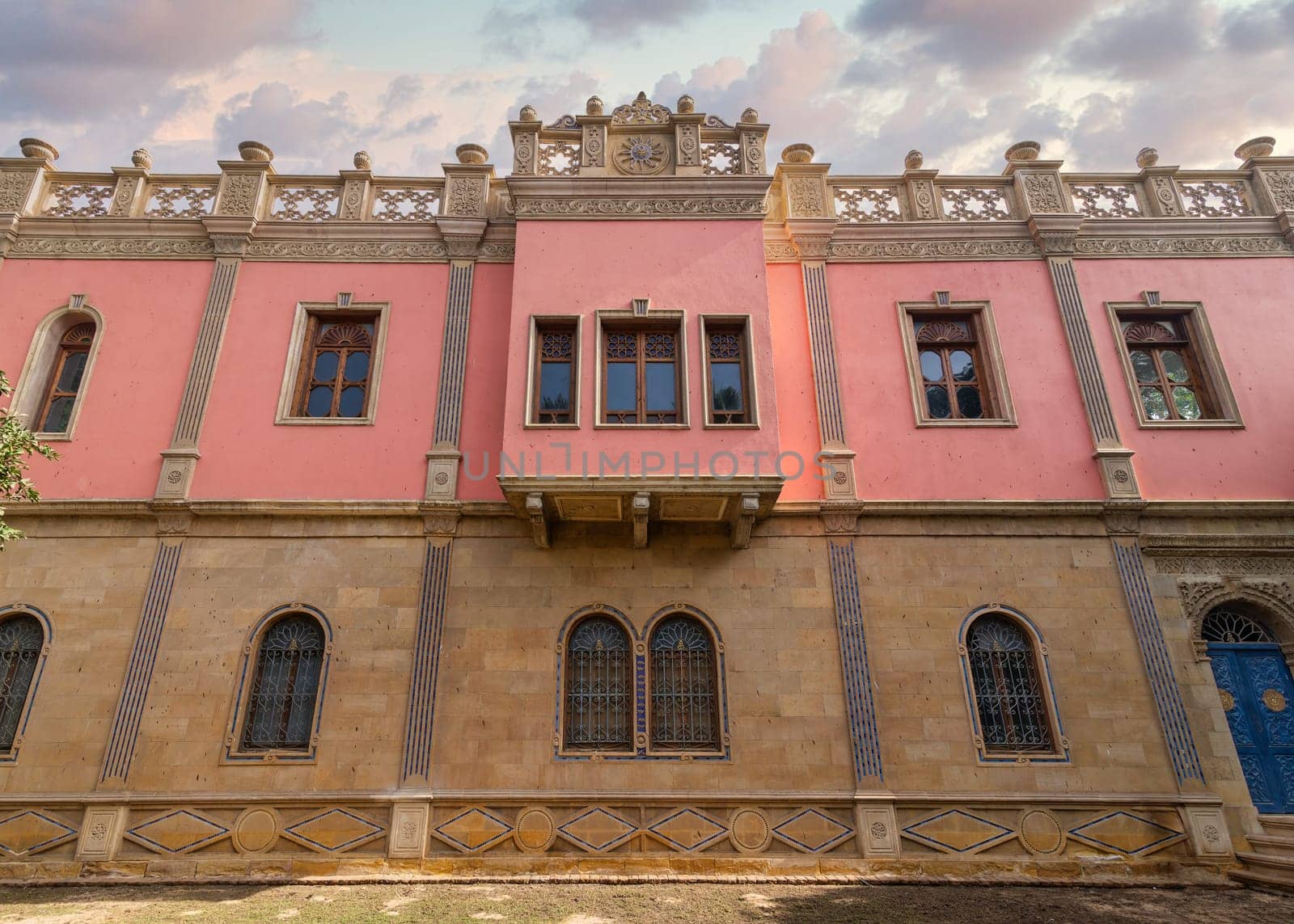 The warm sunset light bathes Prince Naguib Palace in a soft glow, highlighting the intricate Mamluk Architecture, Cairo, Egypt