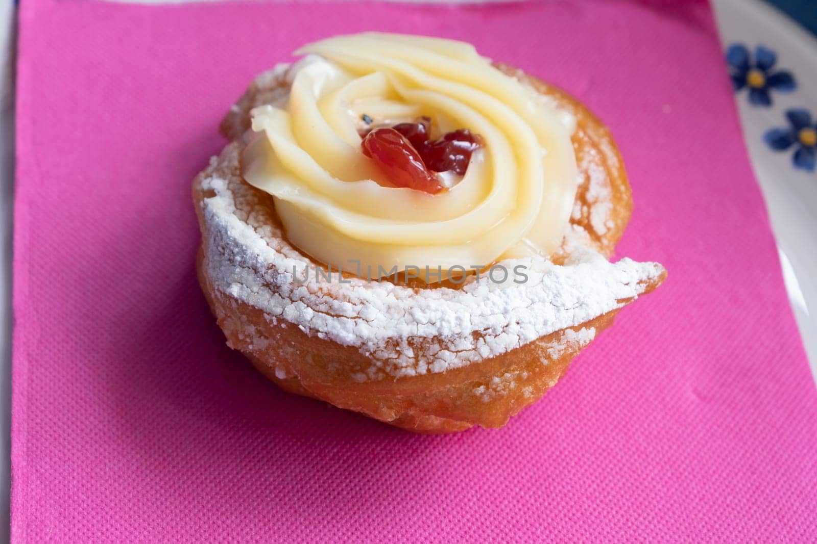 Zeppole of Saint Joseph, Italian pastry with flour, sugar, eggs,  oil, decorated with a sour cherry. Father's Day cake.