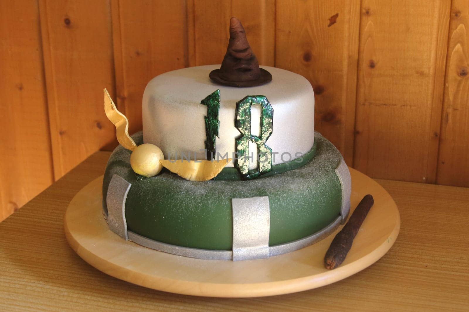 A round chocolate cake with embellishments and an inscription