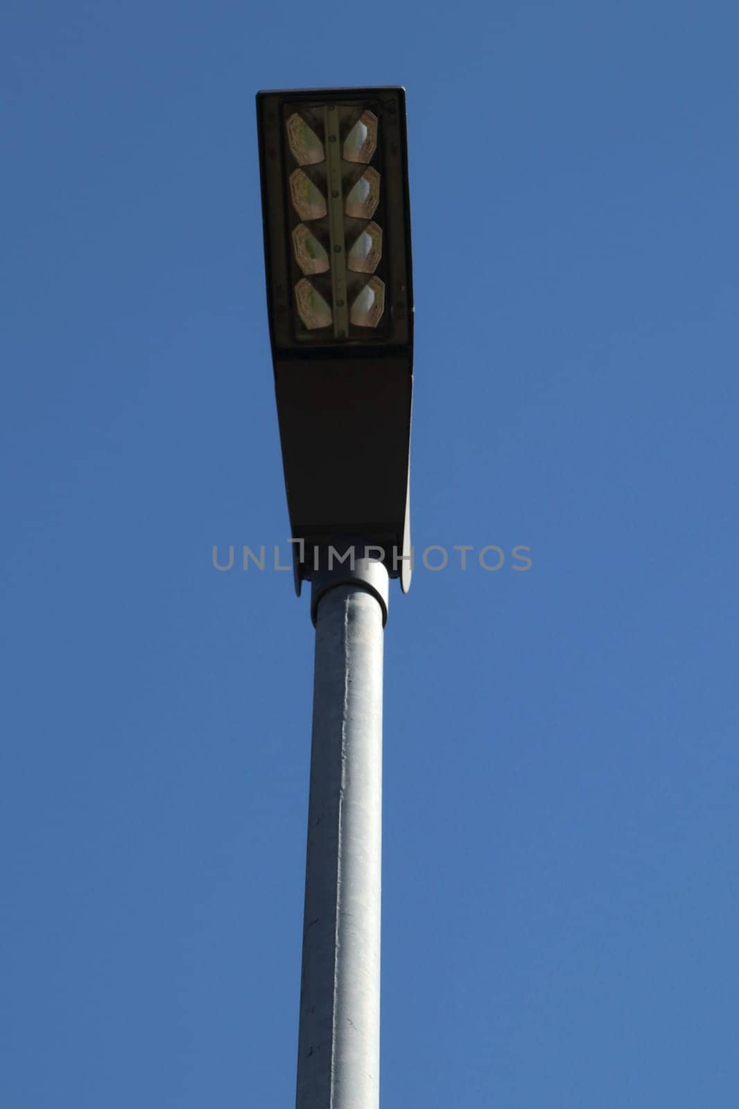 A rectangular street lamp, blue sky in the background