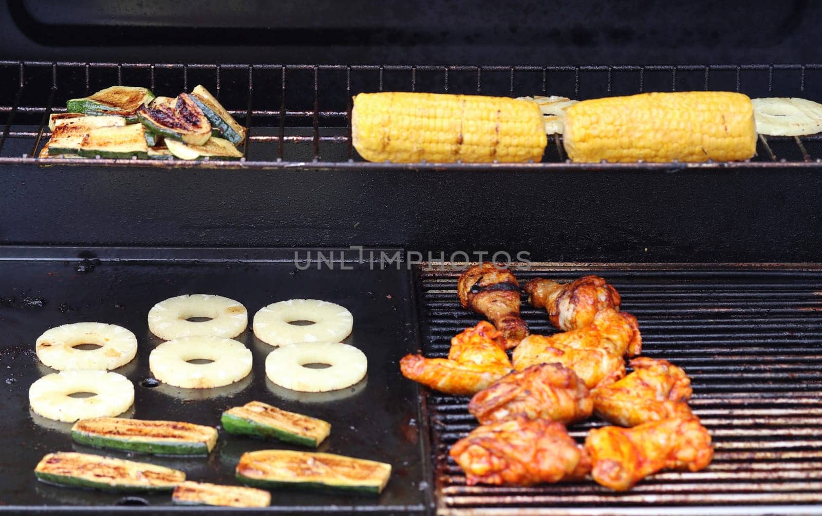 Several pieces of grilled meat on a grill