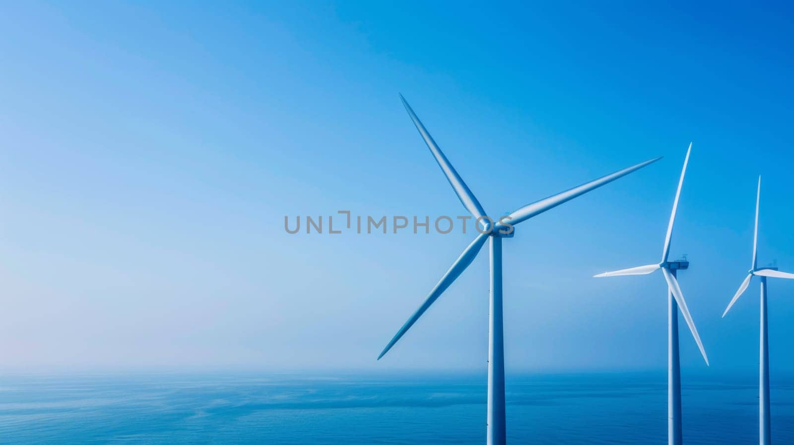 A group of large wind turbines standing in the ocean, harnessing the power of the wind to generate renewable energy. The turbines are connected to the grid through underwater cables, contributing to sustainability efforts.
