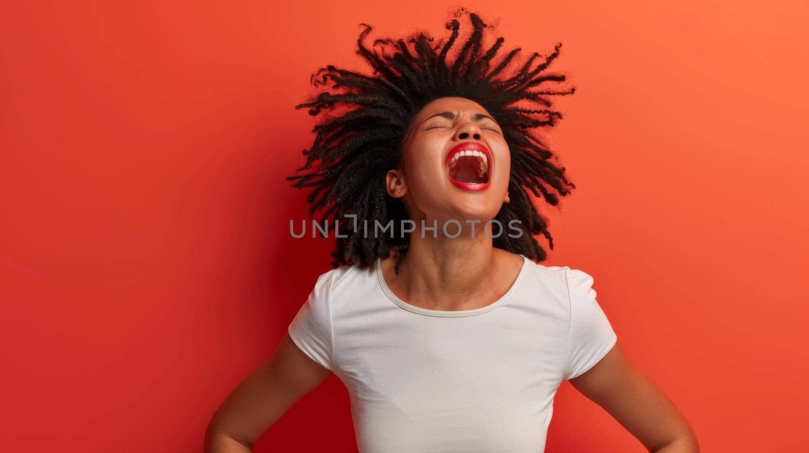 A woman with dreadlocks wearing a white shirt is standing in the image.