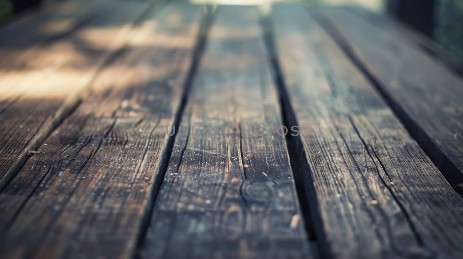 A detailed view of a wooden table is shown up close against a blurred background. The texture of the wood is prominent, and the surface appears to have wear and tear.