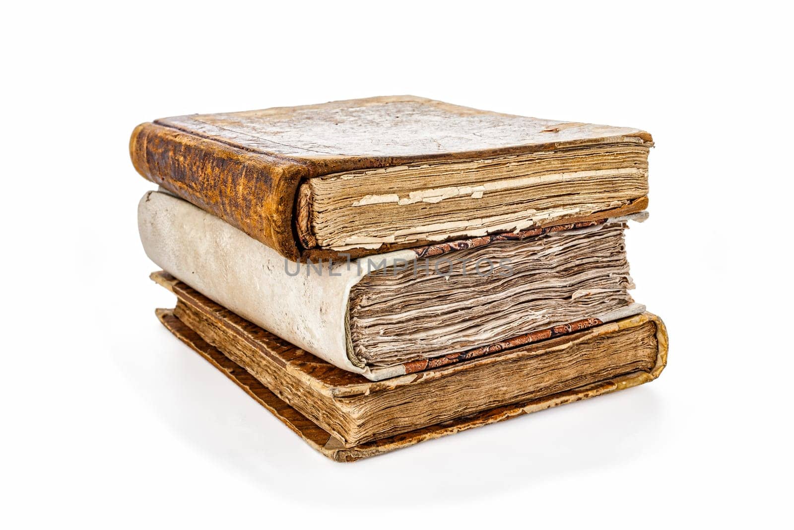 Time-worn books from bygone eras, neatly piled, each with a leather cover that's seen better days. They're remnants of times when literature was exclusive. Presented isolated on white