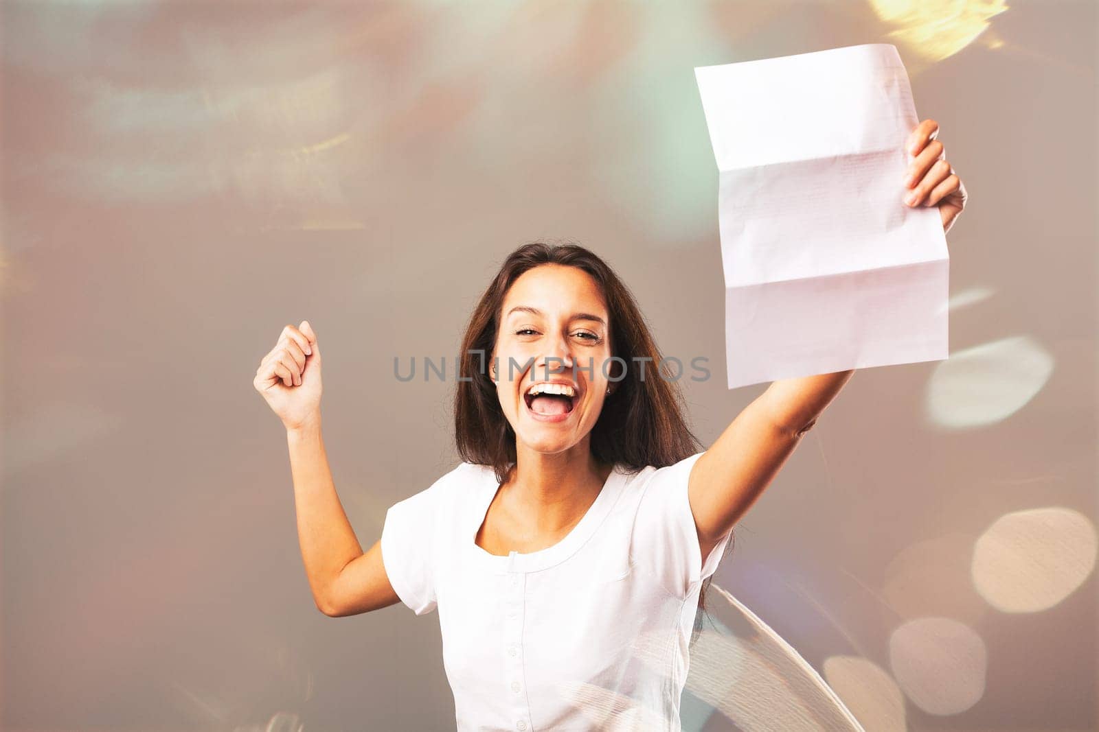 Young woman elated and happy over the written contents of the paper she holds. Her joy seems to stem from excellent news contained in a letter. She cheers with raised arms and laughter. Chaotic graphi