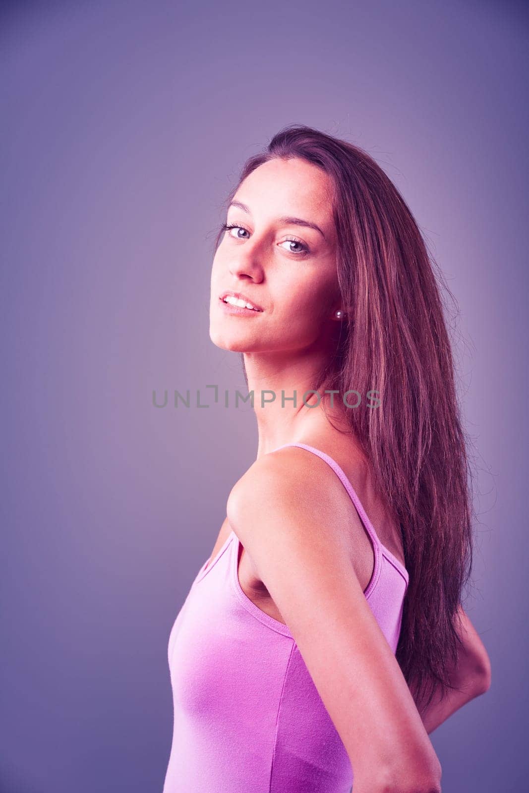 Sexy portrait of a girl feeling alluring. Between profile and three-quarters view, her awareness of being attractive and desirable is visible. Slim, long-haired, and in her prime. It's her moment