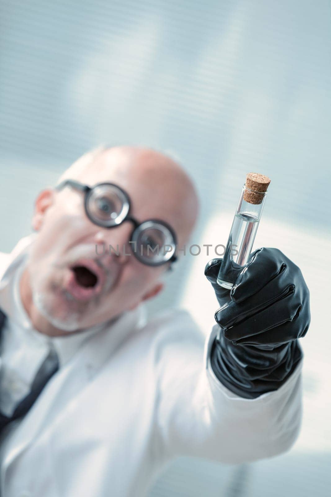 Evil bald professor brandishes a vial, planning world control. His glasses, black gloves, and intellect promise victory over naysayers. Ultimate evil looms