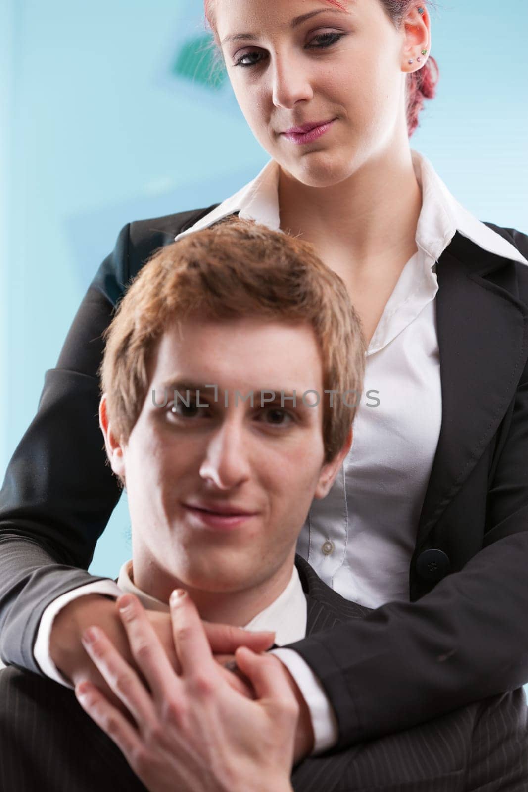 Within business confines, a trusting man is encircled by a possibly scheming woman. The competitive human psyche can drive one to eliminate threats