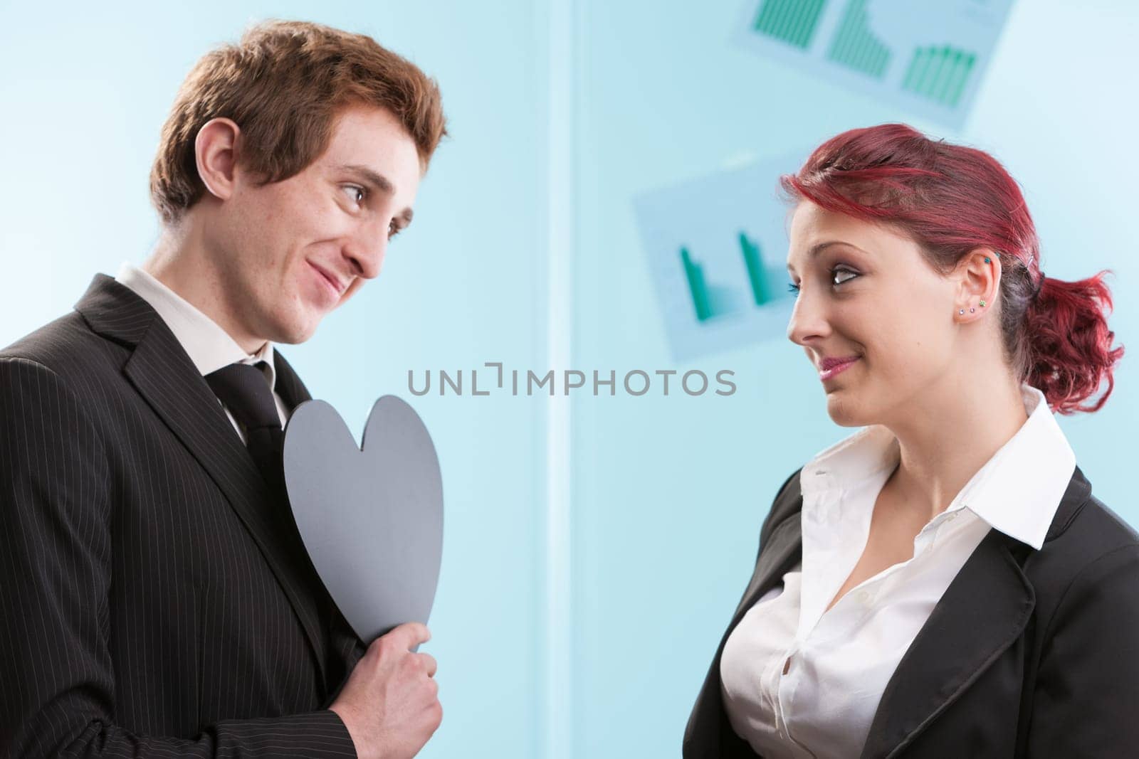 Office romance: He offers a black heart symbol. She's unsure of its meaning. Is it a dark Valentine gesture or just his quirky side?