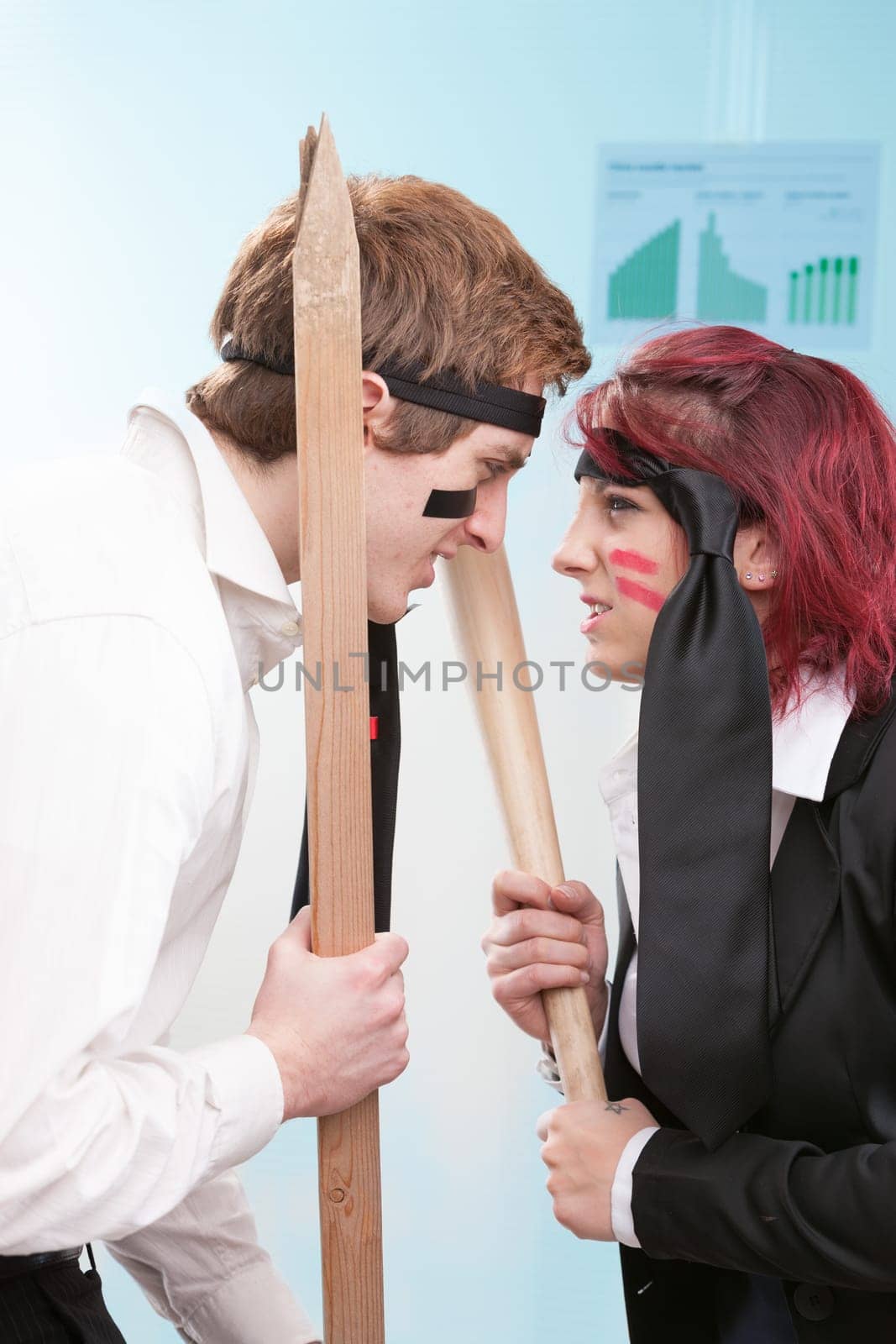 Male and female employees engage in mock combat. Business competition or friendly fire?