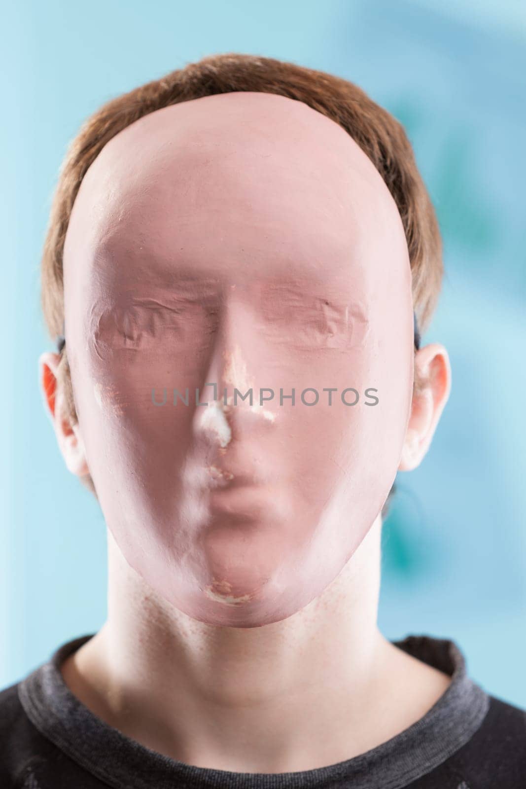 Against a blurry business backdrop, a faceless man with purposeless tools portrays alienation and loneliness