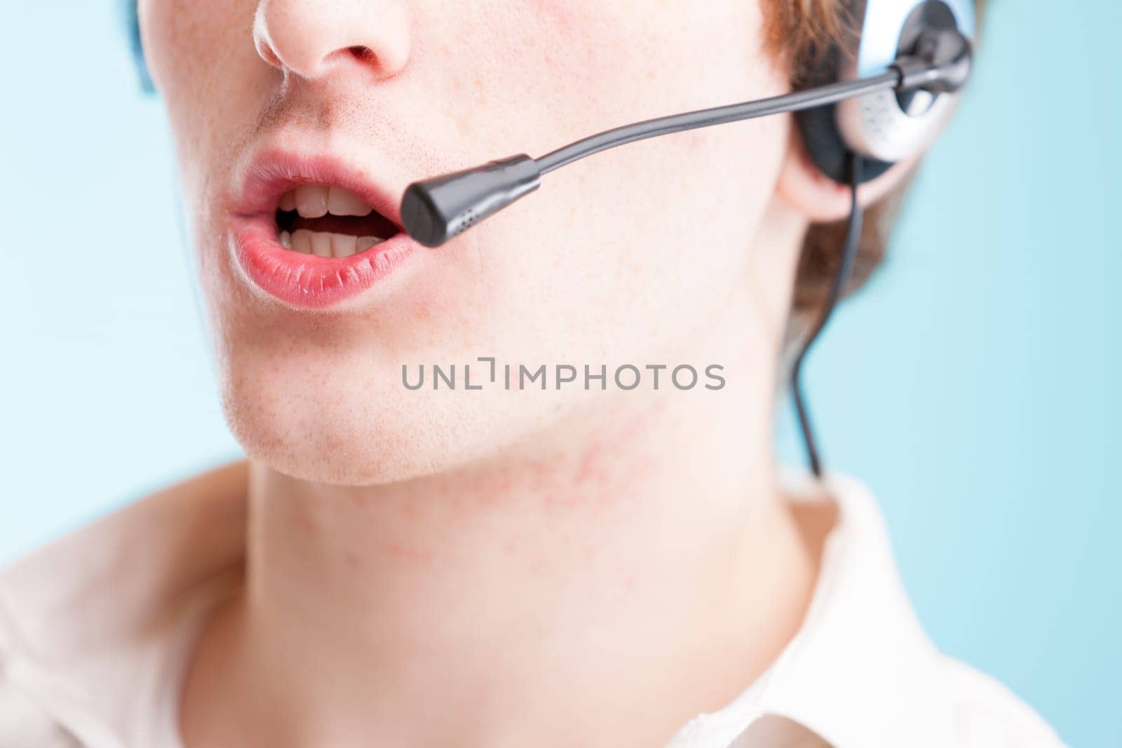 When you think 'contact us,' picture this: close-up of a young man's lips to neck, speaking into a headset. Wearing a white shirt, representing customer assistance, but hailing from an underprivileged