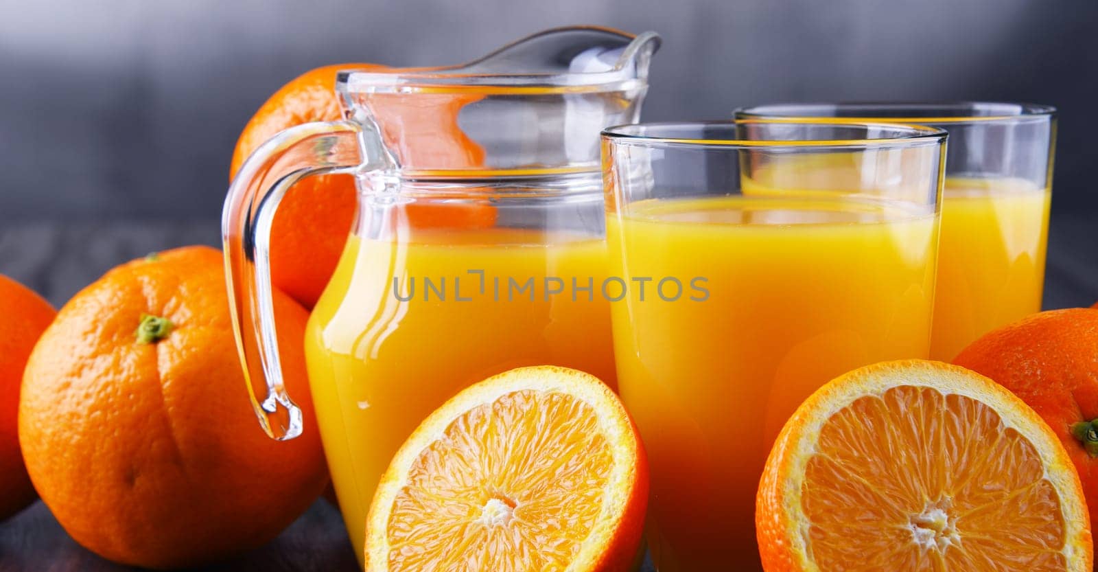 Glasses with freshly squeezed orange juice and fruits