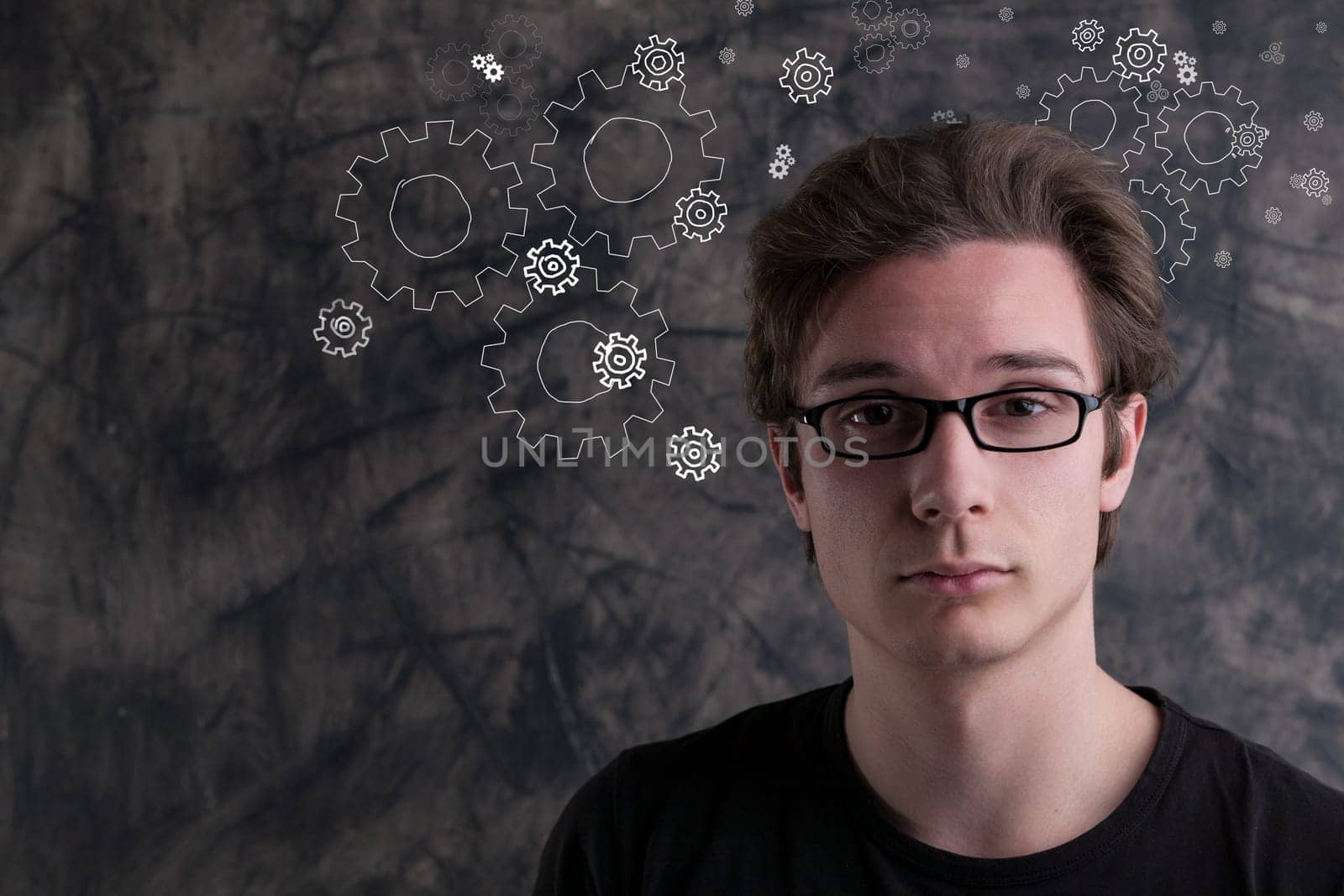 In the realm of creativity and invention, a man stands before grunge, deep in thought. The air showcases gears, ideas, and new creations
