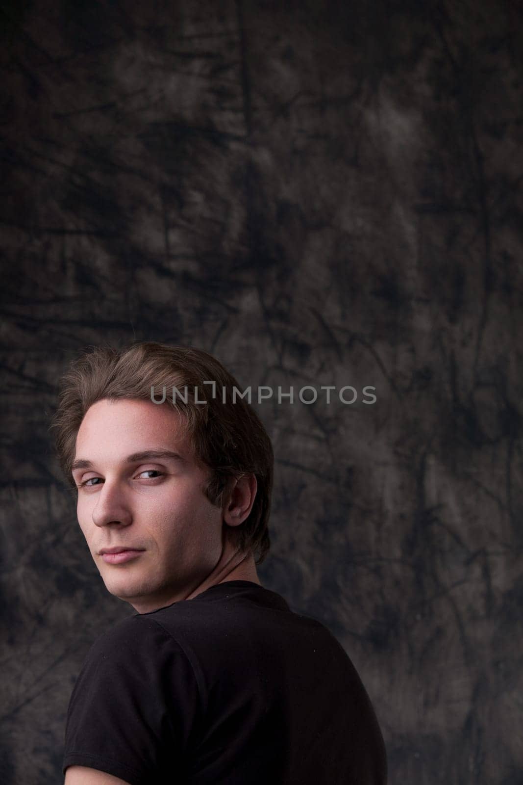 unscrupulous young man plans deceitfully near a board. With ample copyspace, he revels in crafting tricks to exploit others for personal gain