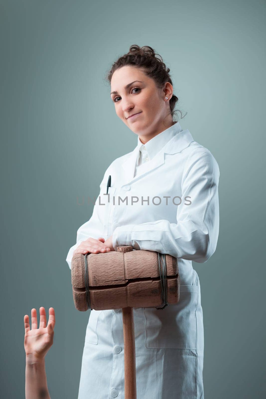 woman in a white coat, holding a 20 KG wooden mallet and knives, smiles unassumingly, yet the context makes her eerie. Representing a malevolent, unethical, and perilous approach in posing as scientis