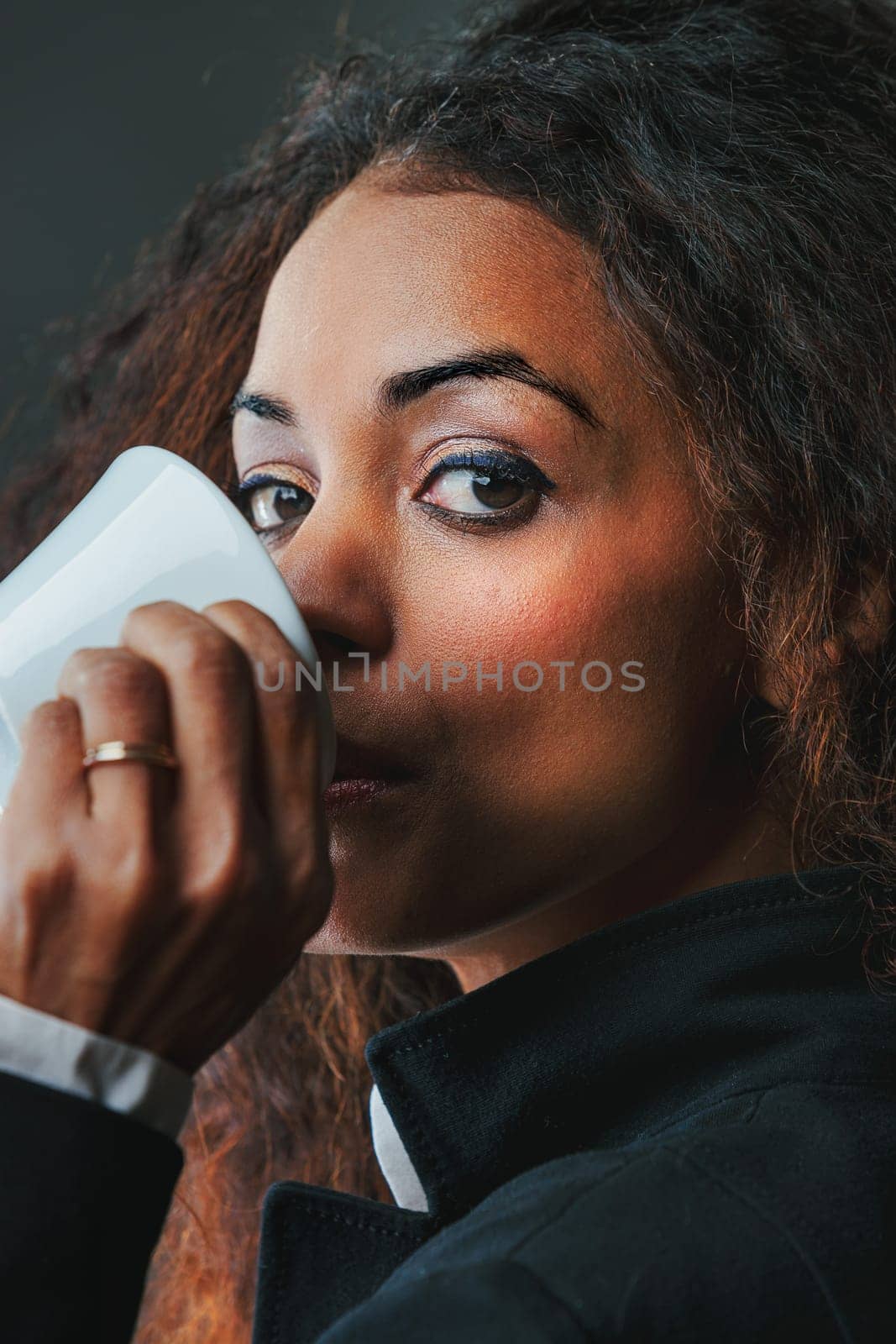 An enchanting black woman drinks her espresso, eyeing the surroundings. Climbing business and societal ranks wasn't accidental it stemmed from being informed, choosing, and adding her sweetness to li