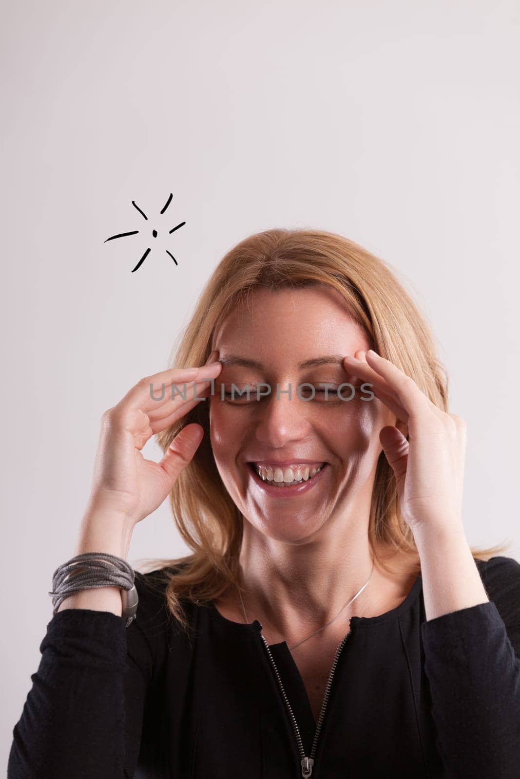Gently smiling, a woman around 40 remembers a previously overlooked task. Without fuss, she calmly accepts the lapse and proceeds to act, embracing the moment with joy