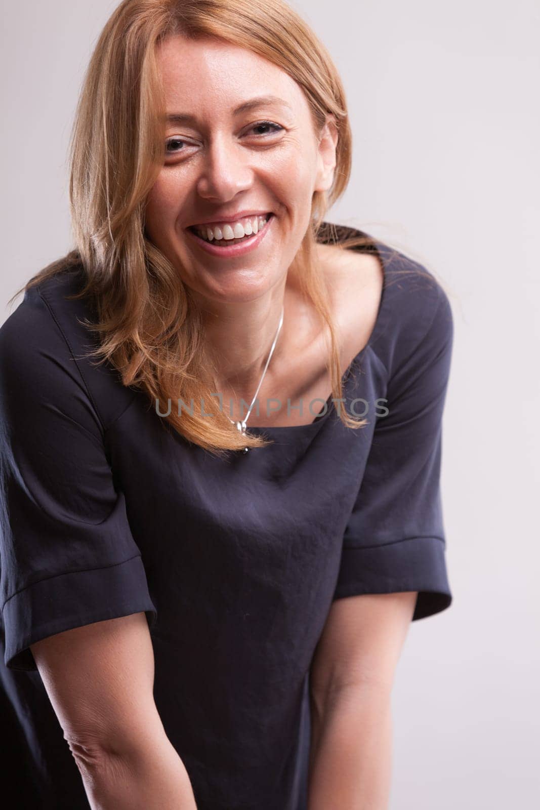 Serene woman, fulfilled with her life's tapestry, smiles broadly. Her joy reciprocates like respiration  internal to external. Gratitude fills her, viewing enhancement as collective gain rather tha