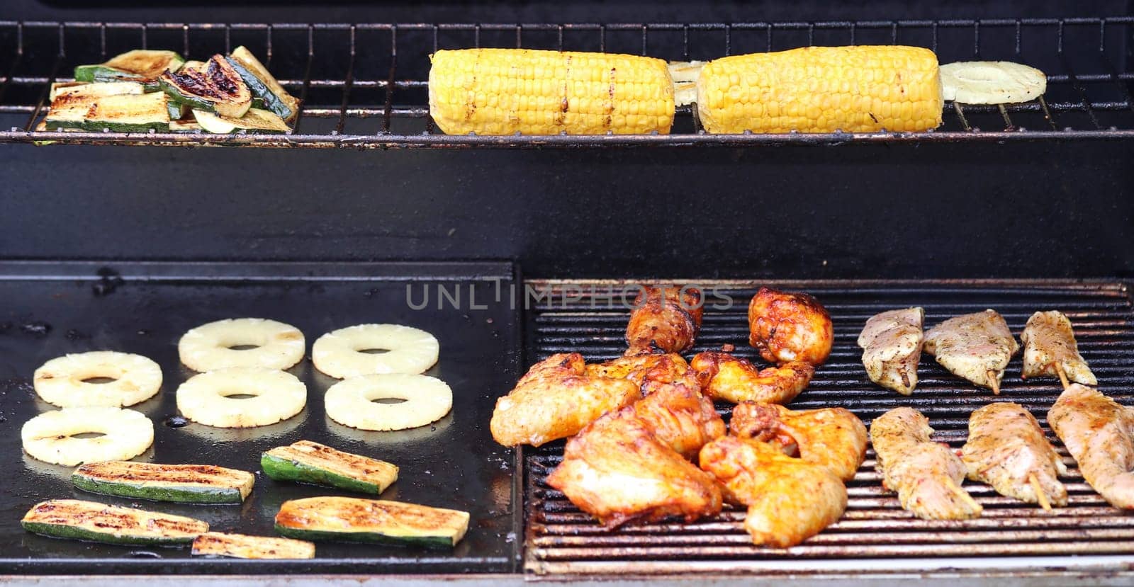 Several pieces of grilled meat on a grill