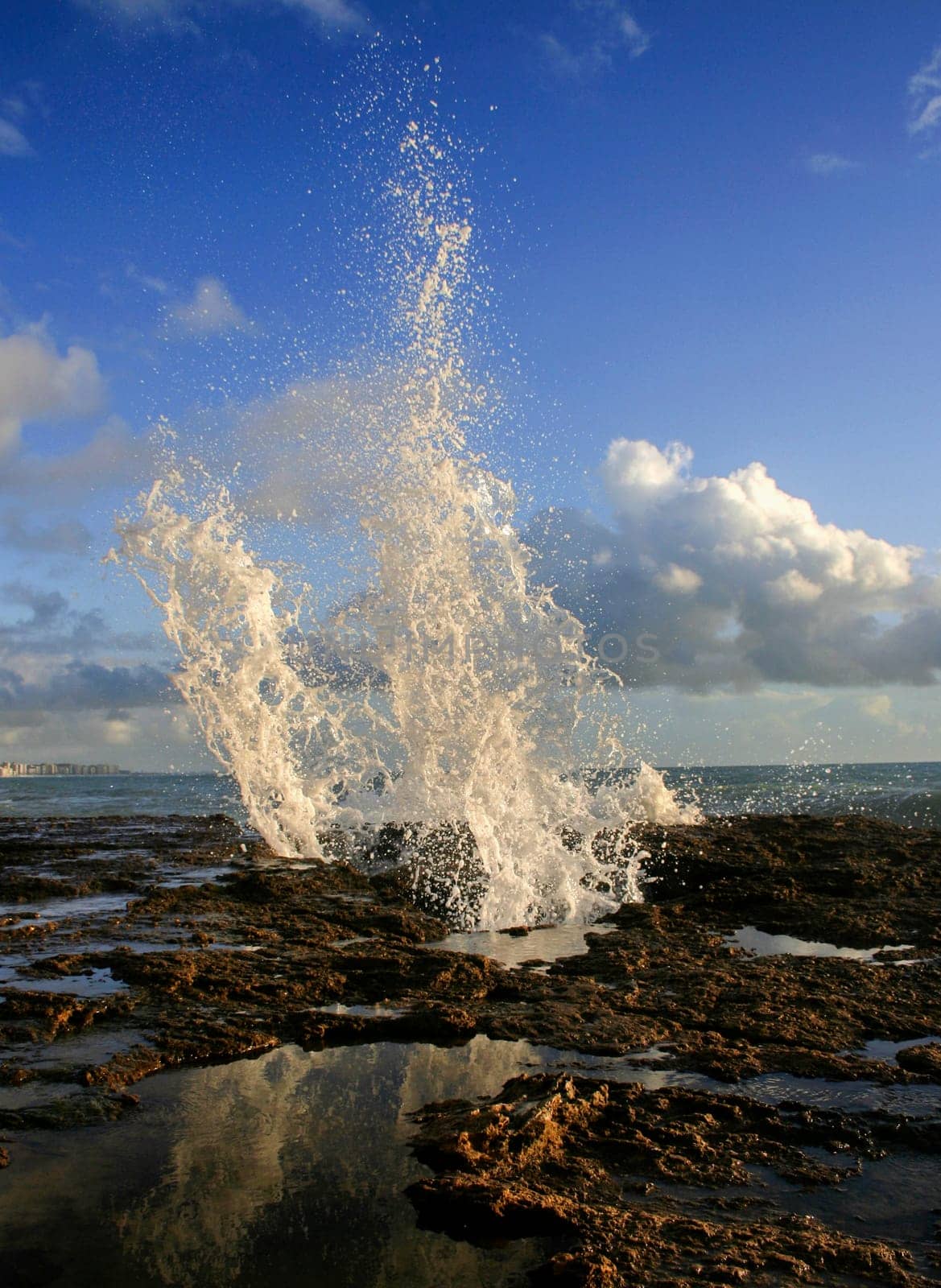 Blowholes at Cadiz city coastline sending burst of water high into the air, Spain