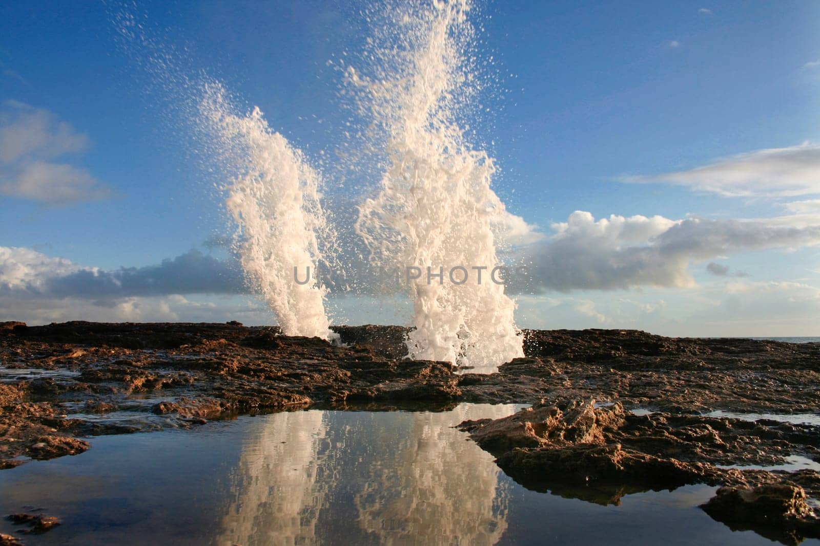 Blowholes at Cadiz city coastline sending burst of water high into the air, Spain