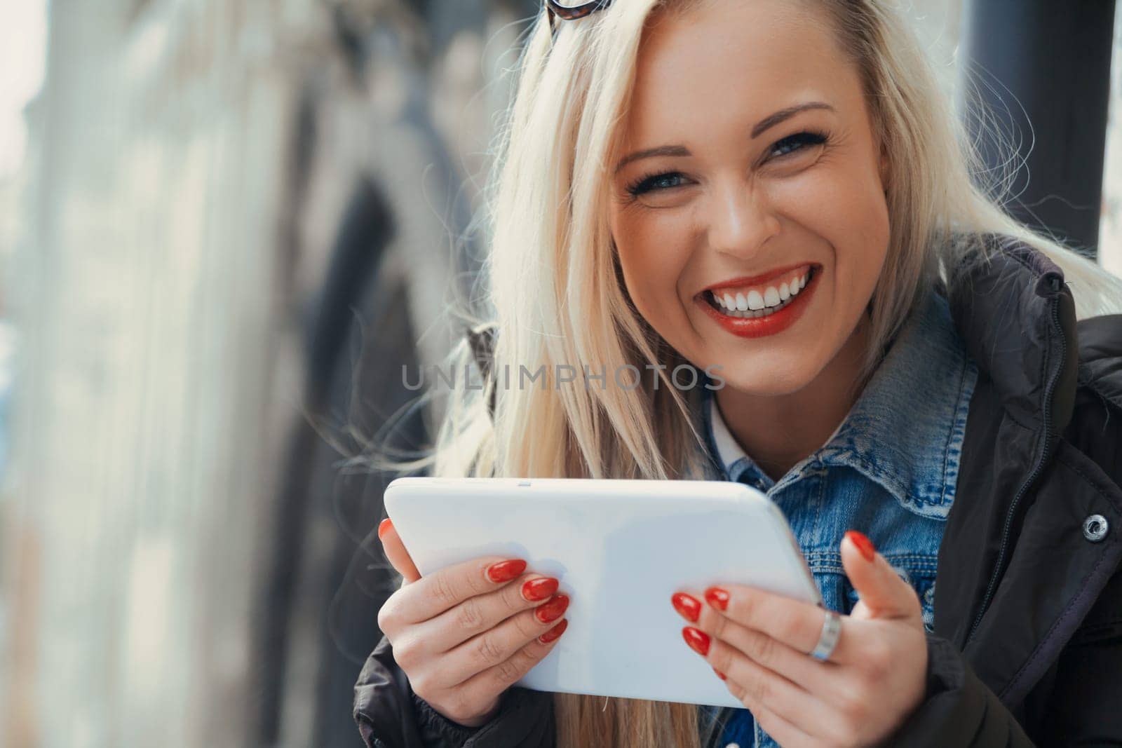 Unprepared but optimistic, a young blonde tourist in Europe utilizes her tablet to navigate the foreign landscape. She accesses maps and guides online, embracing firsthand experiences and a sense of e