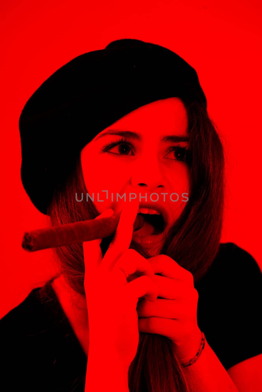 In stark black on red, a portrait emerges of a young woman, beret-clad, holding a cigar, reminiscent of iconic revolutionary imagery. The fervor of youth still untouched by life's mundane responsibili