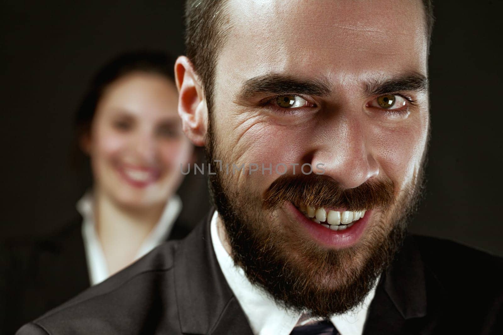 Man (foreground, clear) and woman (background, blurred) depicted as lawyers, government officials, or spies, signifying the importance of choice in alliance or opposition
