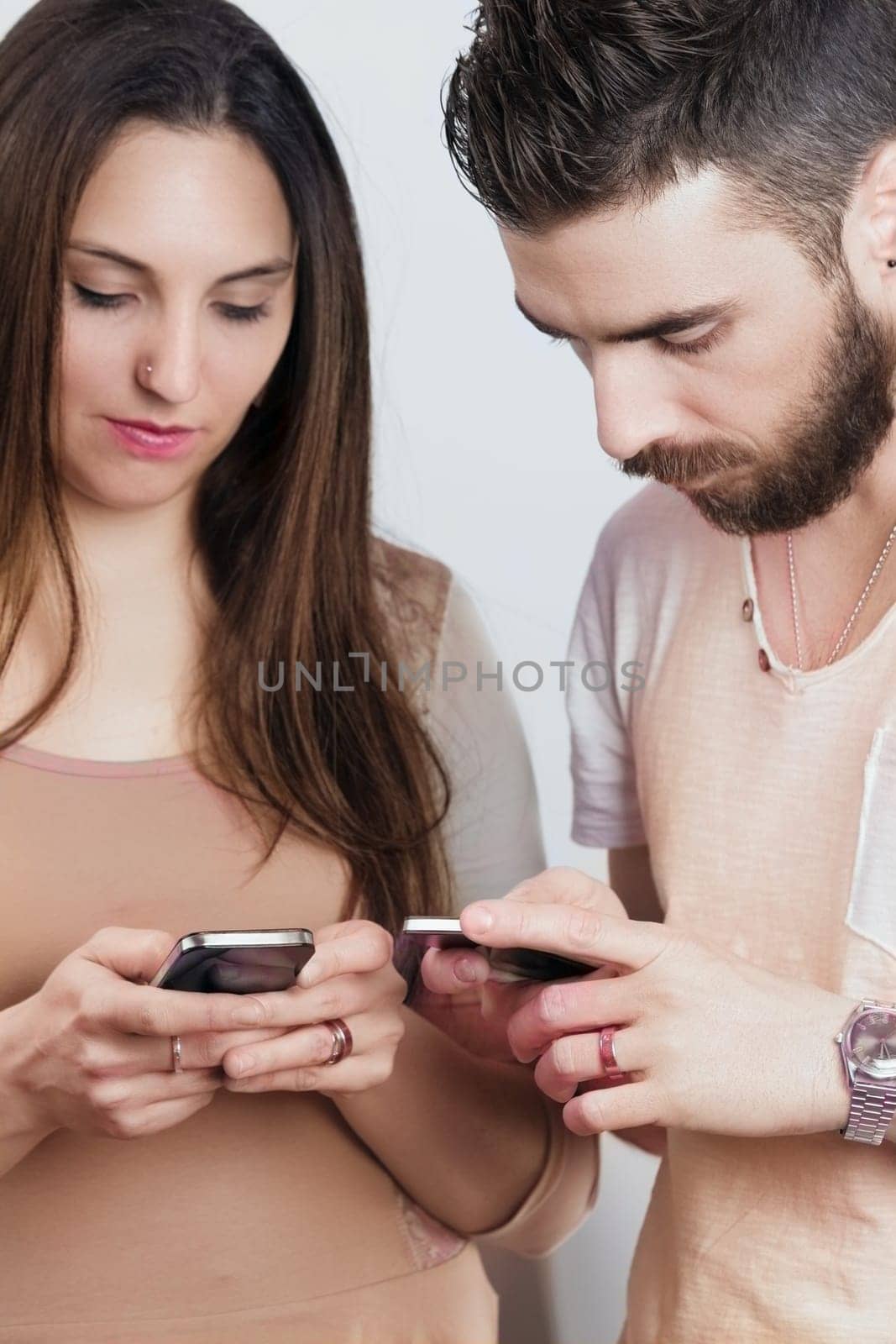 man and woman, close yet distant, are engrossed in their phones. The omnipresence of mobile apps and internet underscores the double-edged nature of working from everywhere, indoors or out