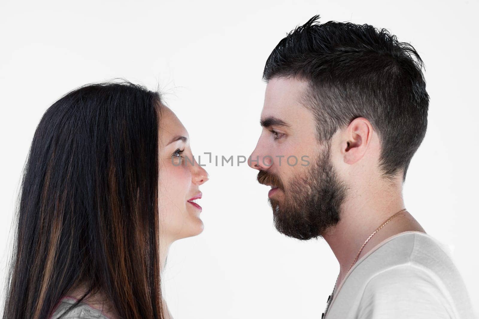 Facing each other, a young couple resists embracing against a white backdrop. It's not their issue, but a reflection on societys transformation into emotionless, Victorian, and puritanical entities