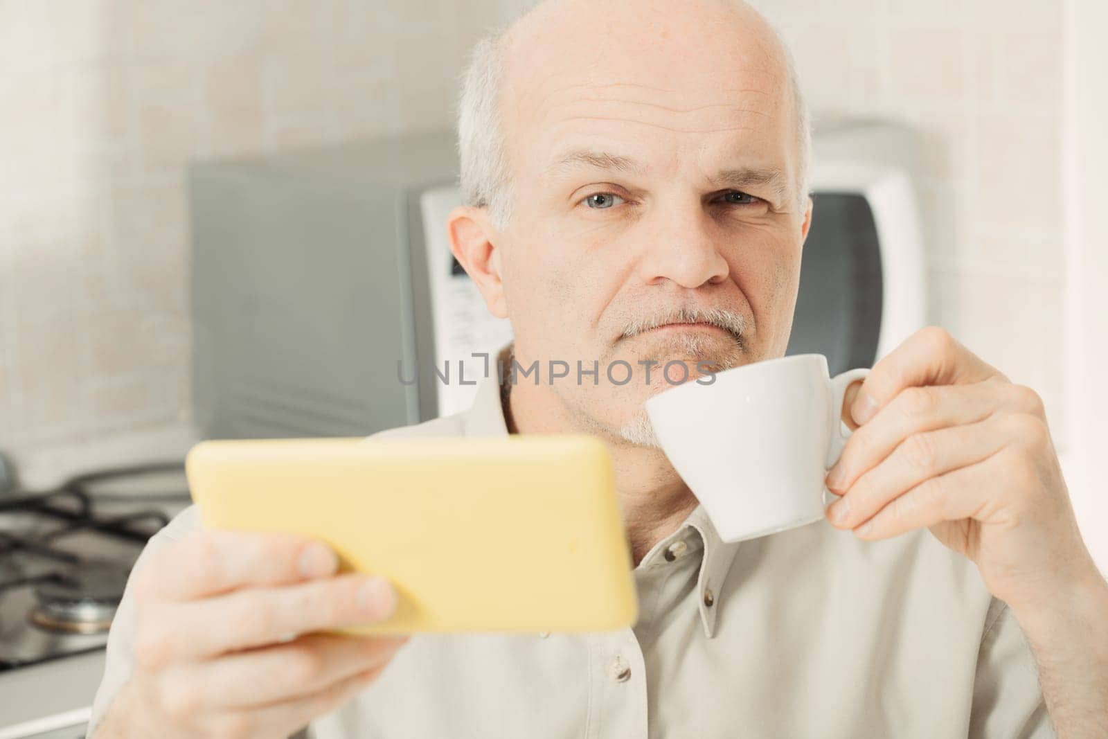 Elderly man, phone in hand, looks skeptical. Fake news makes him feel naive, but he's not. He values critical thinking and verifying sources. Yet, he's tempted, sensing deception everywhere