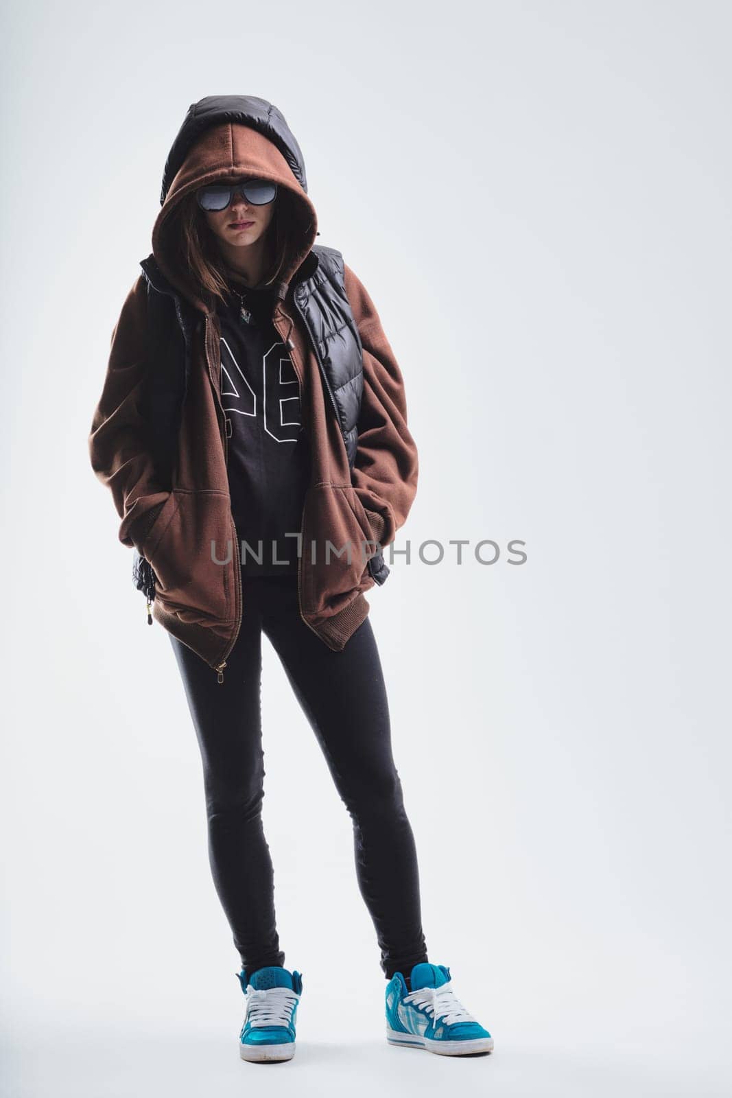 young woman is dressed in an urban casual fashion, highlighting brown and blue hues