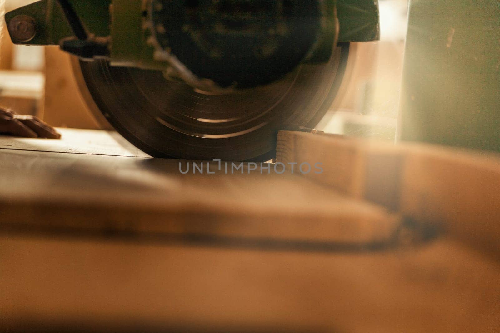 Wood saw while cutting lumber in a woodworking shop.