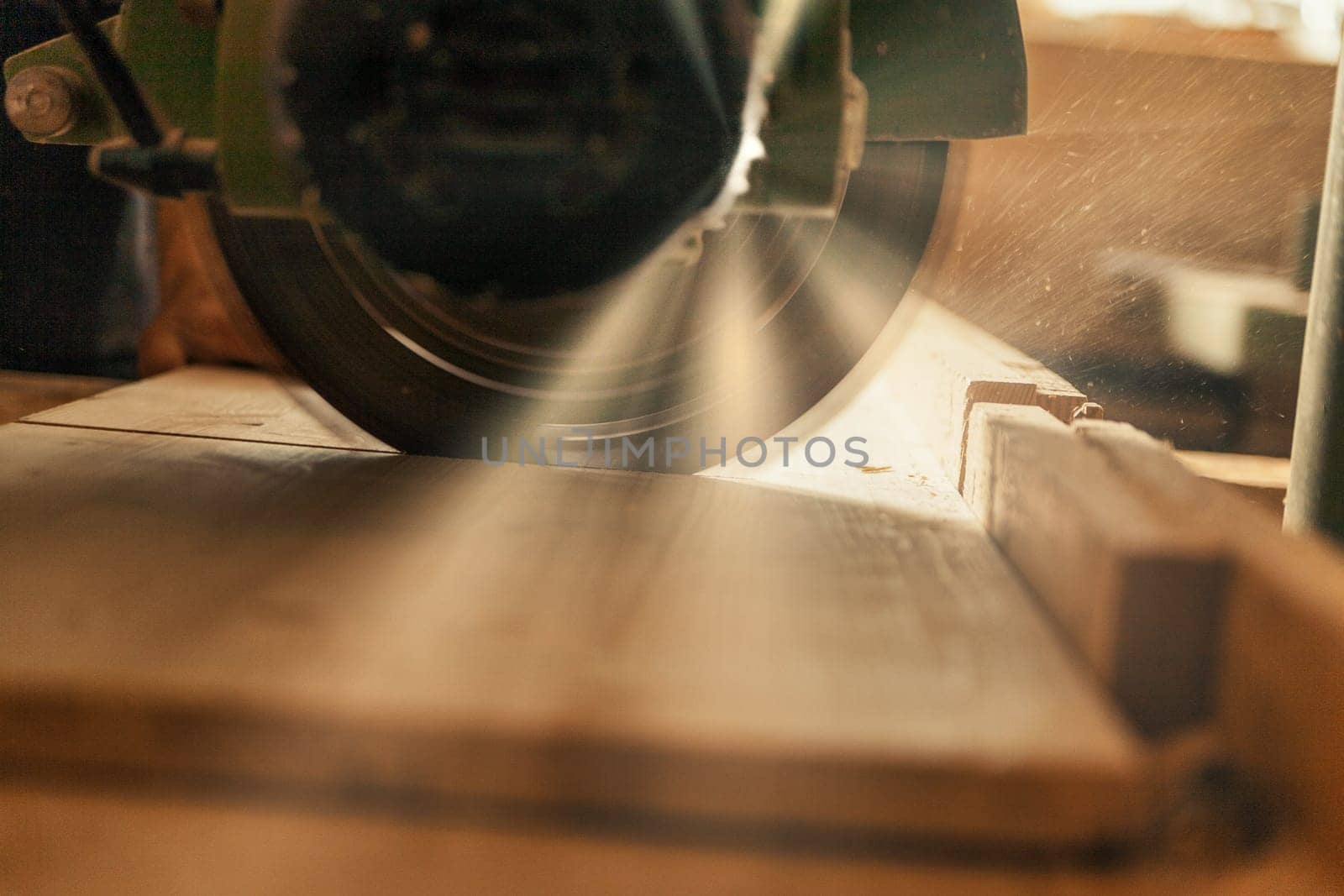 Wood saw while cutting lumber in a woodworking shop.