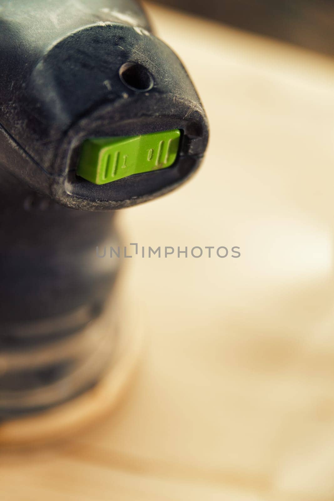 Small detail in focus of an adjustment, knob or in an element of woodworking tools, while the rest remains out of focus. Atmosphere and light in a craftsman carpenter's workshop. Wood and metal.