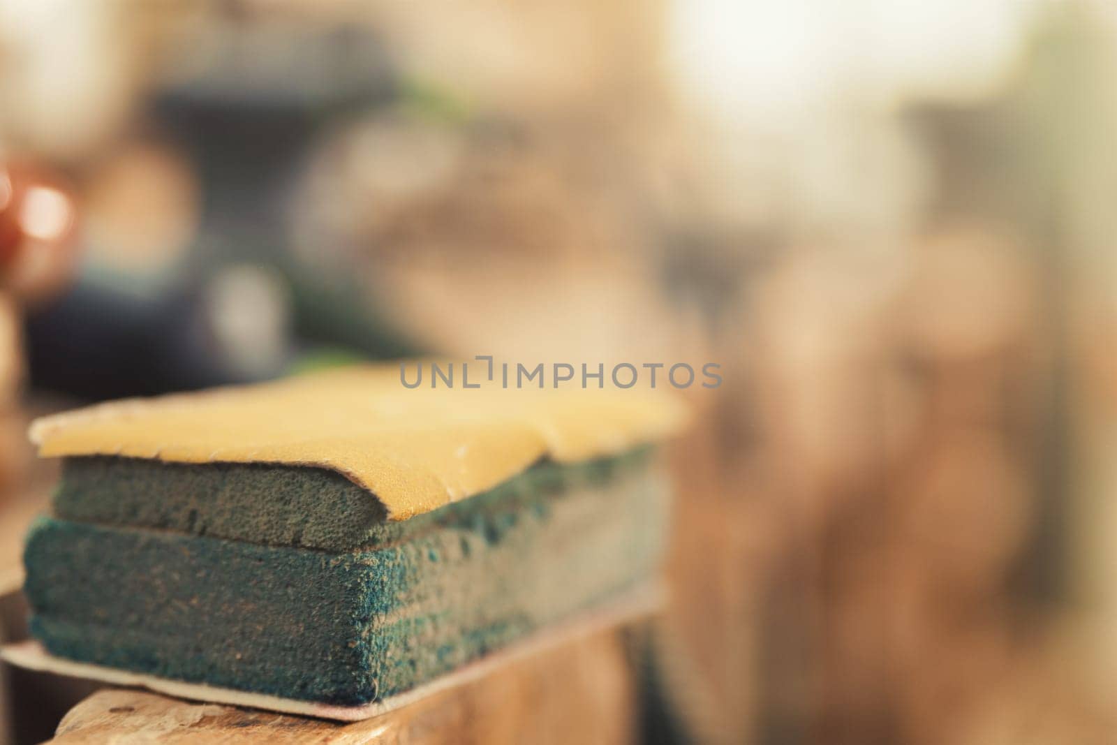 Hand scrapping tool, detail in focus in foreground. Handicraft carpentry blurred in background.