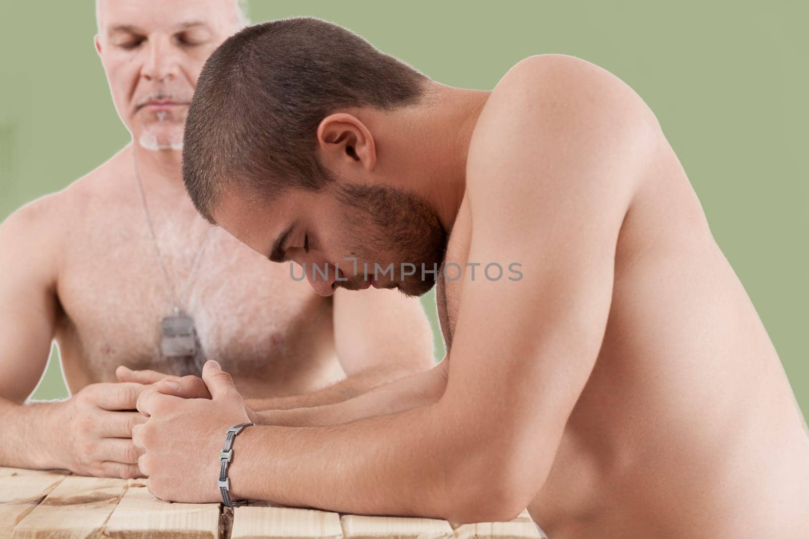 The young man's humble posture contrasts with the elder's military presence