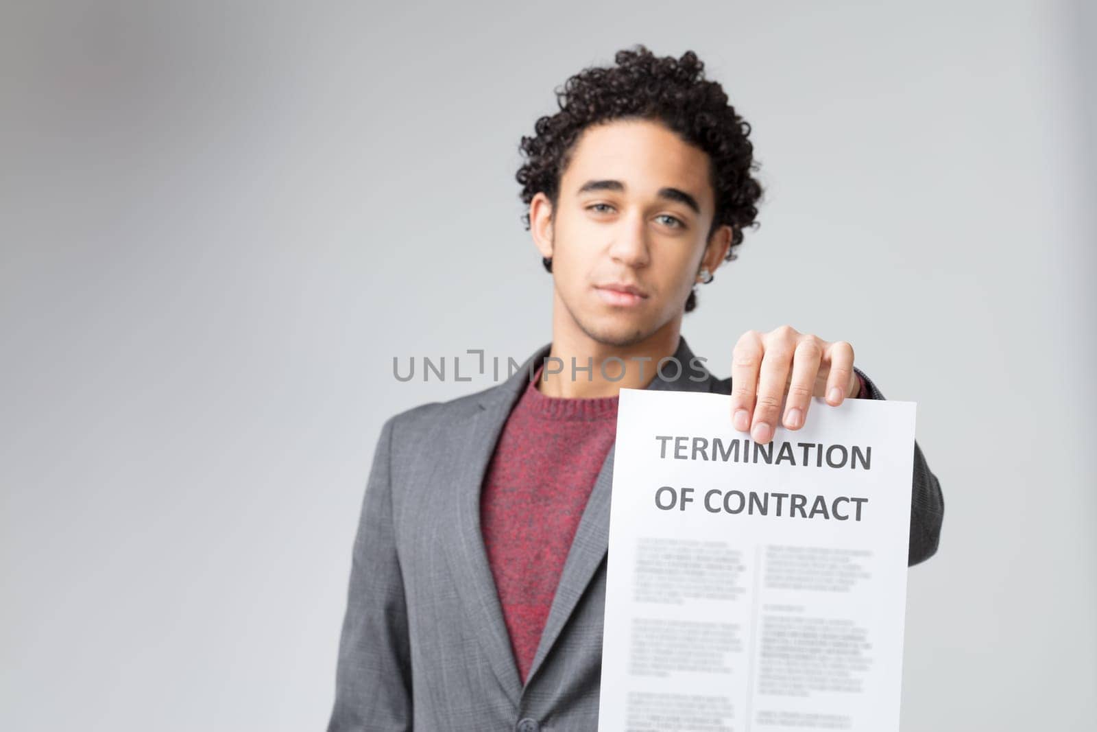 The decisive nature of the 'TERMINATION OF CONTRACT' is accentuated by his earnest expression