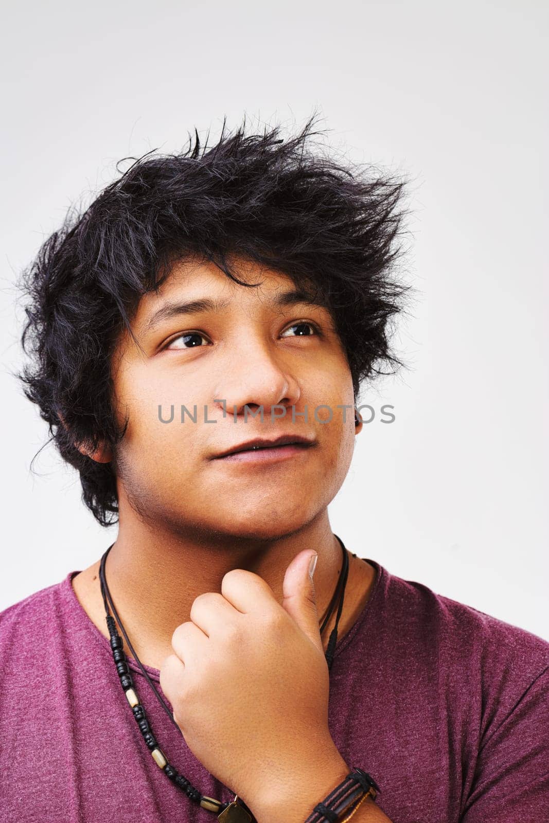 Black-haired young man from Central America muses over an idea that might secure his place in the world through his talents